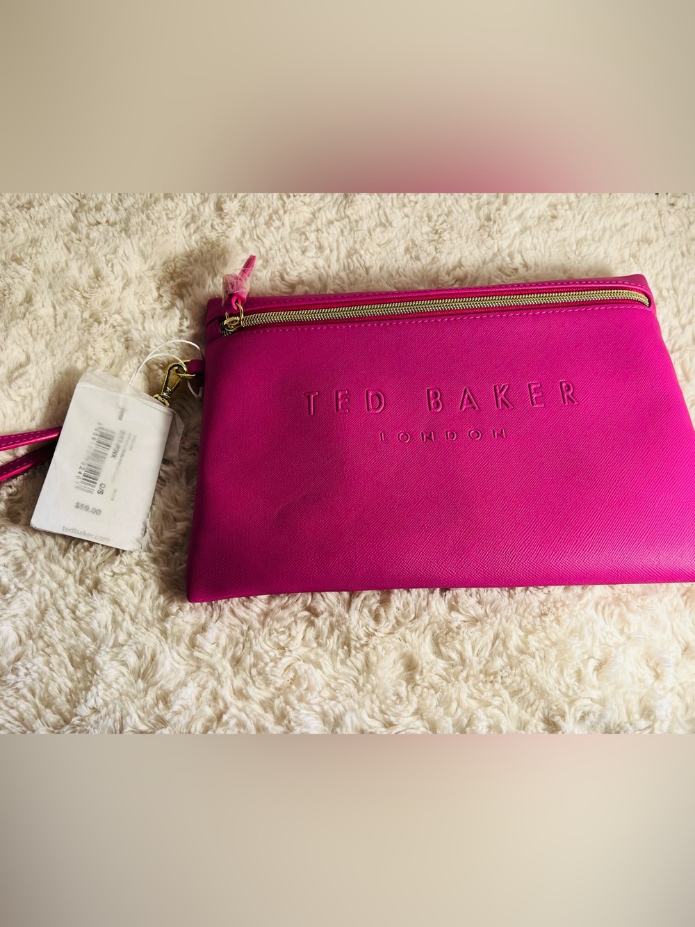 Ted Baker Saffiano Deboss Wristlet Pouch in a bright bubblegum pink hue.
